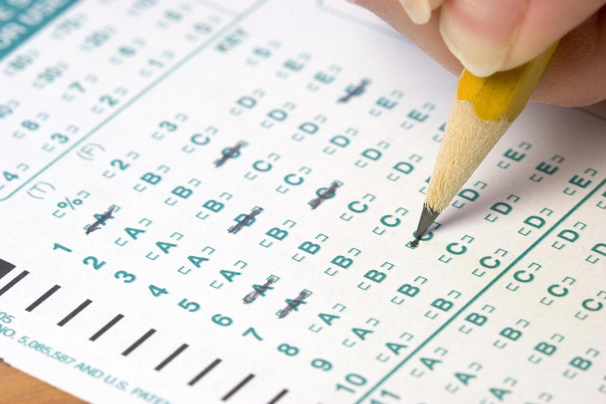 Close-up of a pencil filling in answers on a multiple-choice test sheet